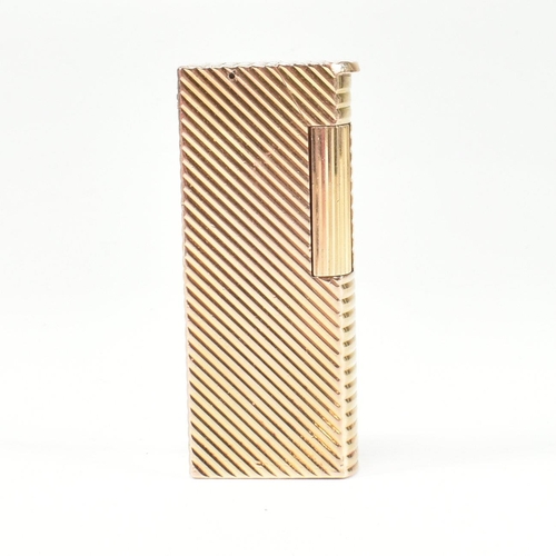 447 - A vintage Dunhill Paris gold plated lighter. The lighter having chevron decoration with roller actio... 