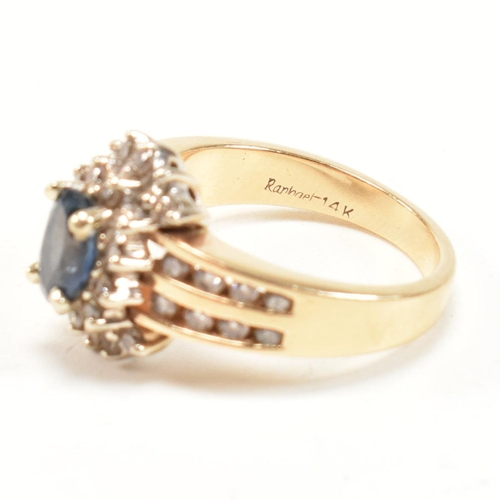 450 - A 14ct gold sapphire and diamond cluster ring. The ring set with an oval cut sapphire framed by roun... 