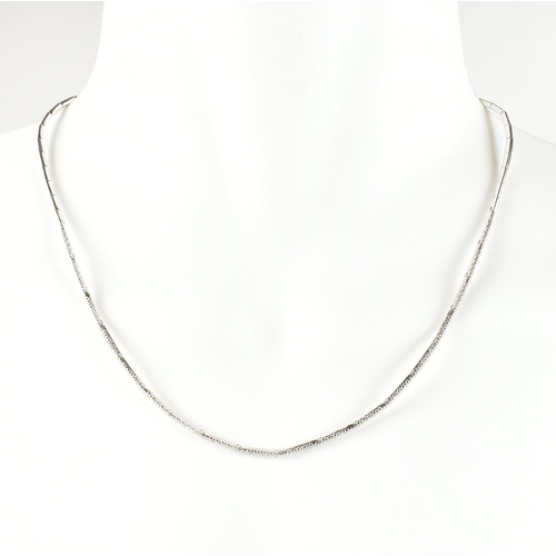 46 - A hallmarked 18ct white gold and diamond line necklace. The necklace having a single row of round cu... 