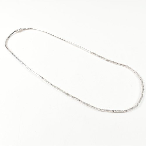 46 - A hallmarked 18ct white gold and diamond line necklace. The necklace having a single row of round cu... 