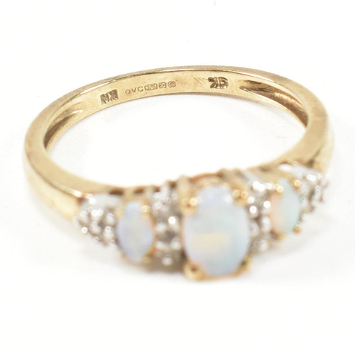 47 - A hallmarked 9ct gold, opal and diamond three stone ring. The ring having three graduating oval opal... 