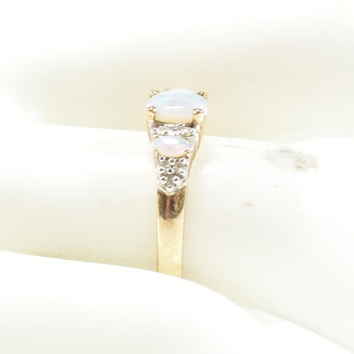 47 - A hallmarked 9ct gold, opal and diamond three stone ring. The ring having three graduating oval opal... 