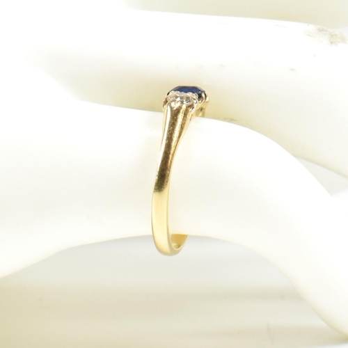 48 - An 18ct gold sapphire & diamond three stone ring. The ring set with a central sapphire flanked by tw... 