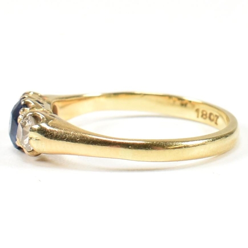 48 - An 18ct gold sapphire & diamond three stone ring. The ring set with a central sapphire flanked by tw... 