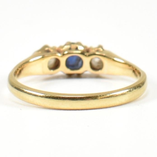 48 - An 18ct gold sapphire & diamond three stone ring. The ring set with a central sapphire flanked by tw... 