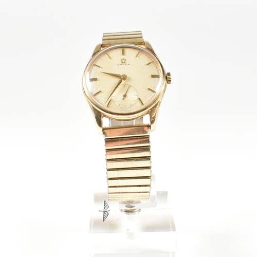 50 - A 1960s 9ct gold Omega wristwatch. Champagne dial with baton markers  and seconds dial at the lower ... 