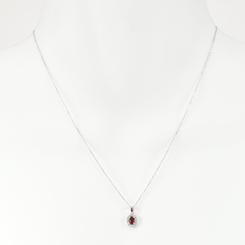 54 - A hallmarked 18ct gold ruby and diamond pendant necklace. The necklace strung with a ruby and diamon... 