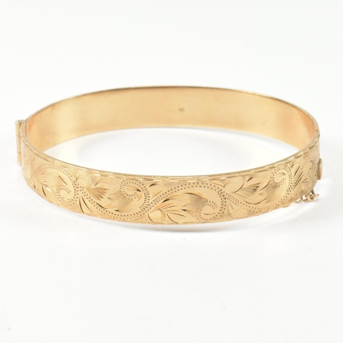 57 - A hallmarked 9ct gold hinged bangle and a pair of 9ct gold hoop earrings. The lot to include a hallm... 