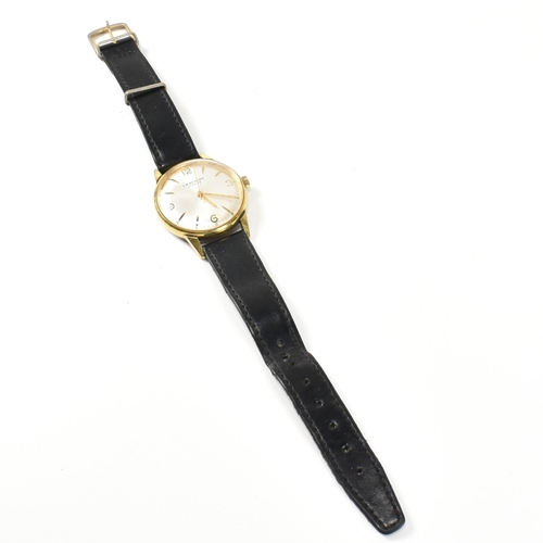 59 - A vintage J. W. Benson London Swiss made wristwatch. The watch having a circular silvered dial with ... 