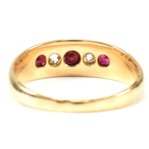 61 - A Victorian 18ct gold ruby and diamond five stone ring. The ring set with three round cut rubies and... 