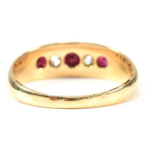 61 - A Victorian 18ct gold ruby and diamond five stone ring. The ring set with three round cut rubies and... 