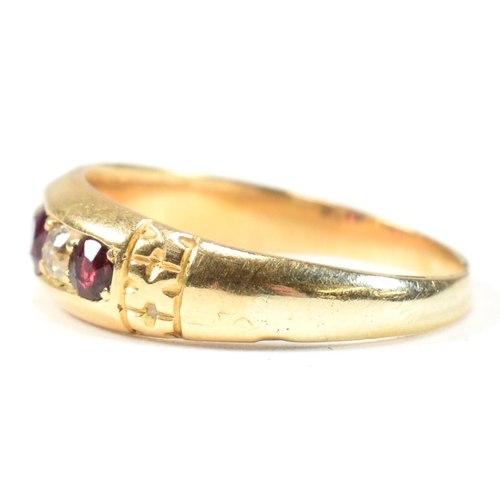 61 - A Victorian 18ct gold ruby and diamond five stone ring. The ring set with three round cut rubies and... 