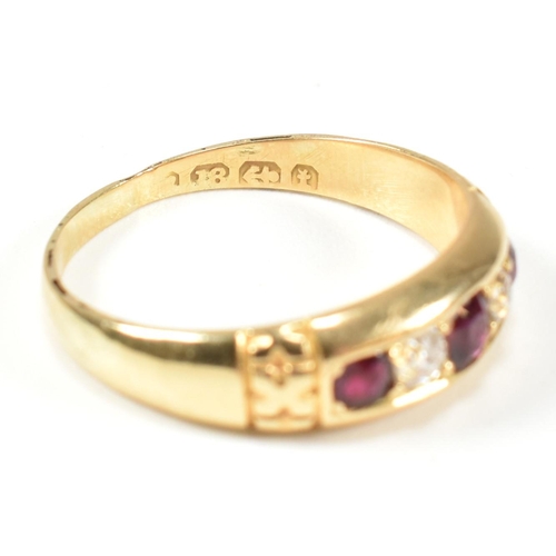 61 - A Victorian 18ct gold ruby and diamond five stone ring. The ring set with three round cut rubies and... 