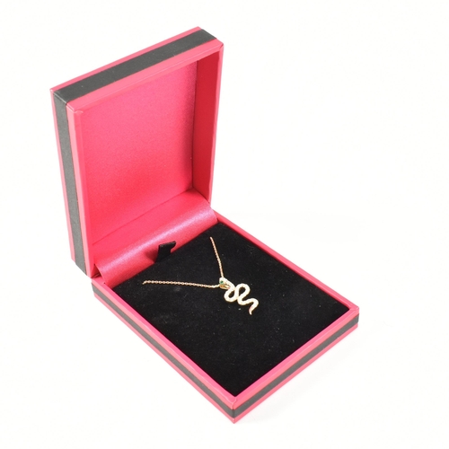 62 - A 9ct gold and diamond pendant necklace. The necklace strung with a pendant in the form of a snake e... 