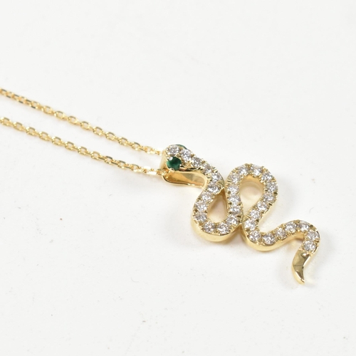 62 - A 9ct gold and diamond pendant necklace. The necklace strung with a pendant in the form of a snake e... 