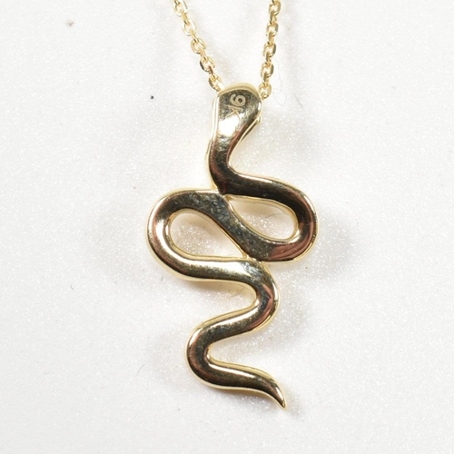 62 - A 9ct gold and diamond pendant necklace. The necklace strung with a pendant in the form of a snake e... 