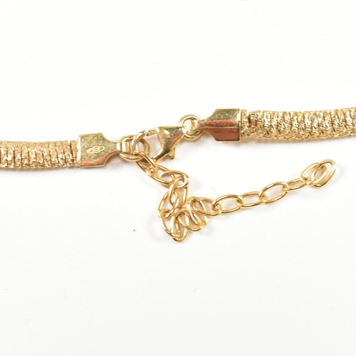 63 - A hallmarked 9ct gold flat textured snake chain necklace. The necklace having a 9ct gold textured me... 