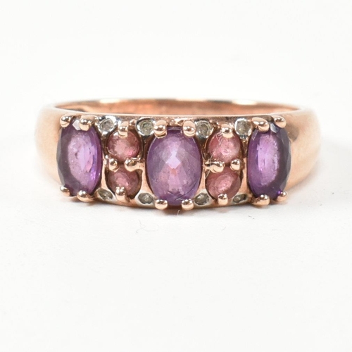 65 - A hallmarked 9ct rose gold, diamond, amethyst and tourmaline ring. The ring set with three oval cut ... 