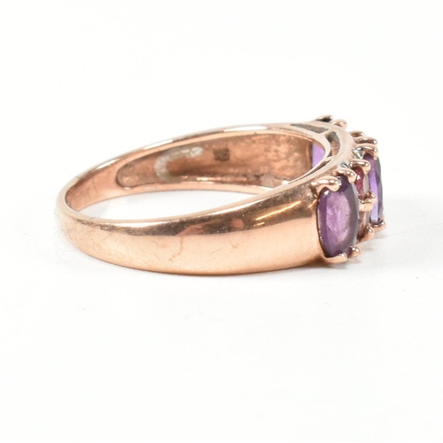 65 - A hallmarked 9ct rose gold, diamond, amethyst and tourmaline ring. The ring set with three oval cut ... 