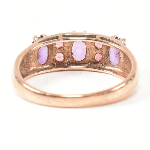 65 - A hallmarked 9ct rose gold, diamond, amethyst and tourmaline ring. The ring set with three oval cut ... 