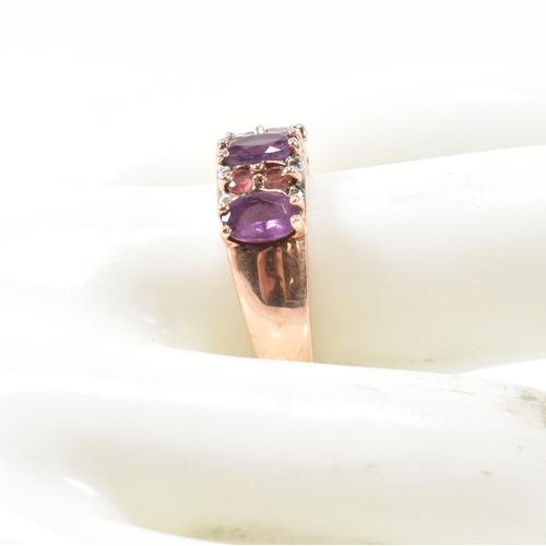 65 - A hallmarked 9ct rose gold, diamond, amethyst and tourmaline ring. The ring set with three oval cut ... 