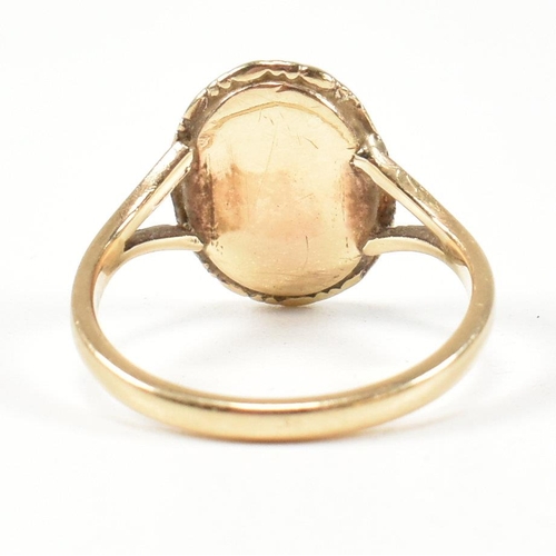 68 - A 19th century gold cameo ring. The ring set with a carved shell cameo of a figure in a closed back ... 