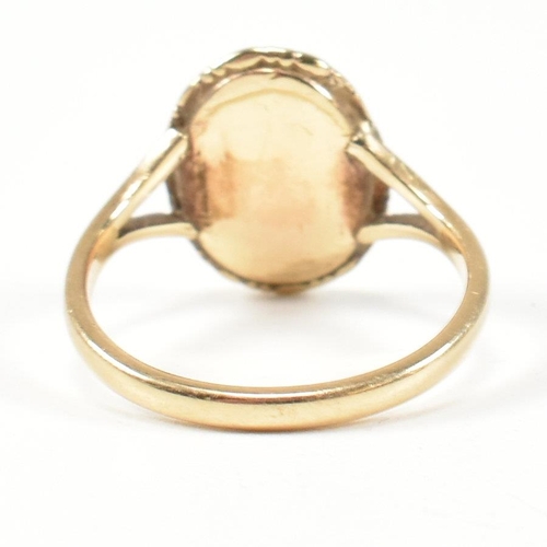 68 - A 19th century gold cameo ring. The ring set with a carved shell cameo of a figure in a closed back ... 