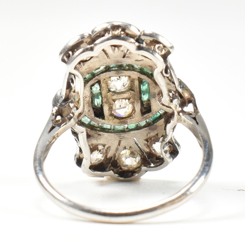 7 - An Art Deco platinum emerald and diamond ring. The ring set with calibre cut emeralds and old cut di... 