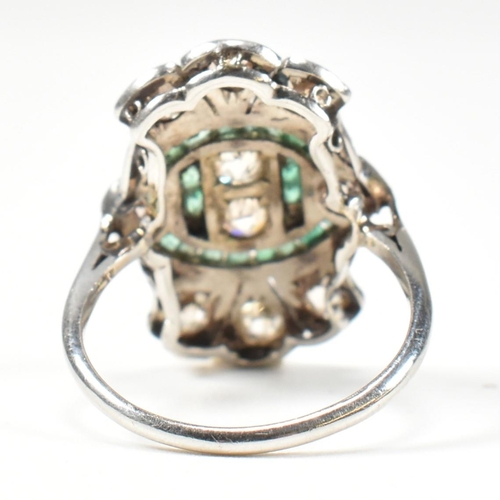 7 - An Art Deco platinum emerald and diamond ring. The ring set with calibre cut emeralds and old cut di... 