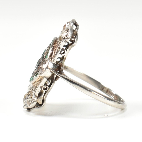 7 - An Art Deco platinum emerald and diamond ring. The ring set with calibre cut emeralds and old cut di... 