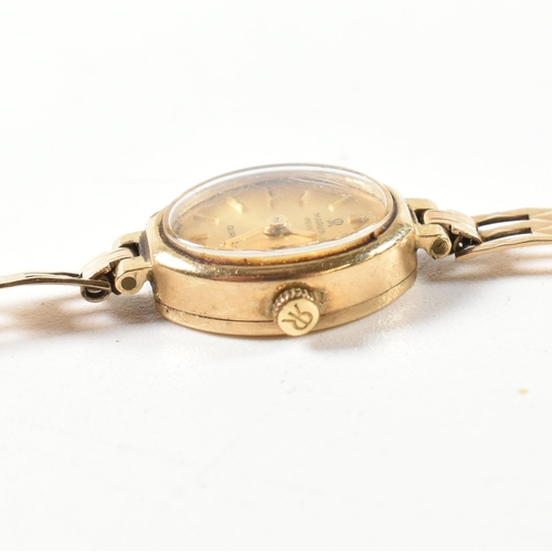 70 - A hallmarked 9ct gold Marvin Revue wristwatch. The watch having a champagne dial with baton number m... 