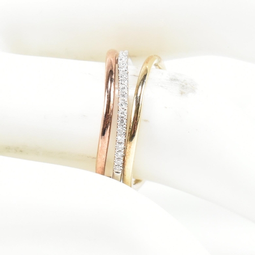 73 - A hallmarked 9ct gold and diamond tri colour gold stacking ring set. Size N. Weighs 3.2g. All weight... 