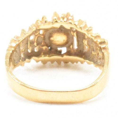 74 - A vintage 18ct yellow gold and pearl dress ring. The brutalist style ring having a pierced bark effe... 