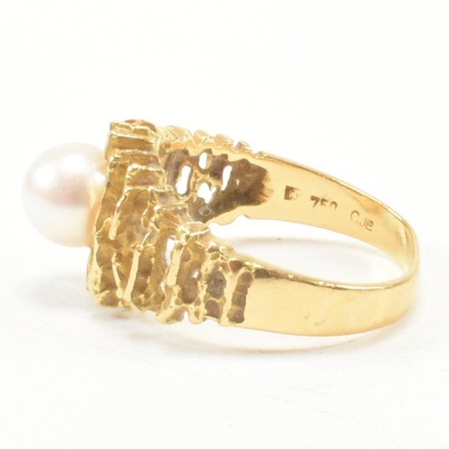 74 - A vintage 18ct yellow gold and pearl dress ring. The brutalist style ring having a pierced bark effe... 