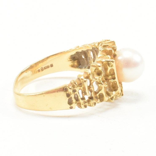 74 - A vintage 18ct yellow gold and pearl dress ring. The brutalist style ring having a pierced bark effe... 