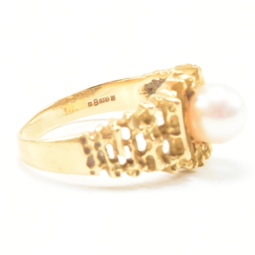 74 - A vintage 18ct yellow gold and pearl dress ring. The brutalist style ring having a pierced bark effe... 