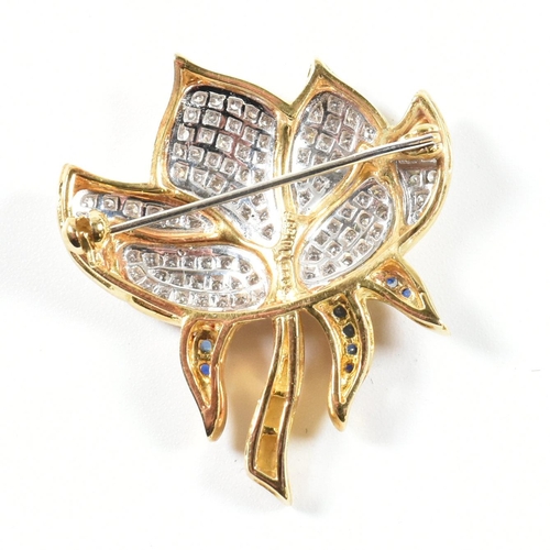 76 - A hallmarked 18ct gold, sapphire and diamond lotus flower brooch pin. The lotus flower brooch pin ha... 