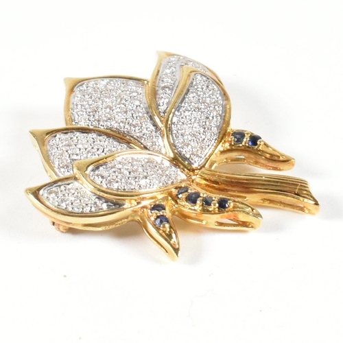 76 - A hallmarked 18ct gold, sapphire and diamond lotus flower brooch pin. The lotus flower brooch pin ha... 