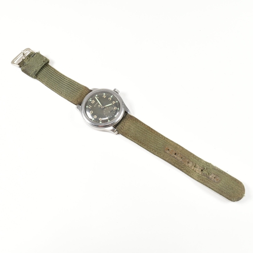 77 - A World War II military Cyma Dirty Dozen wristwatch. The watch having a circular black dial with rad... 