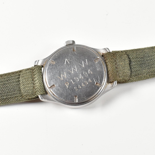 77 - A World War II military Cyma Dirty Dozen wristwatch. The watch having a circular black dial with rad... 