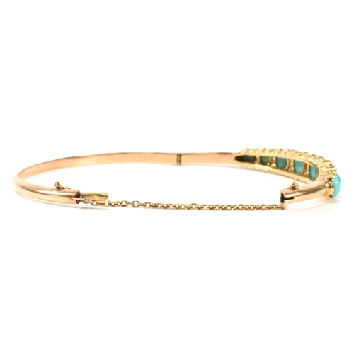 8 - A late Victorian gold, turquoise and diamond hinged bangle. The gold hinged bangle set with nine gra... 