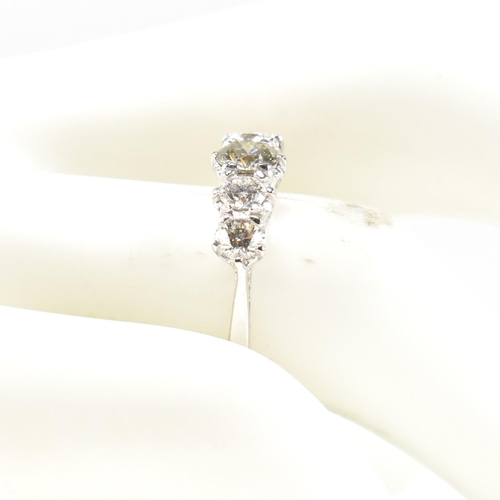 82 - A white gold and diamond five stone ring. The ring set with five graduating round brilliant cut diam... 