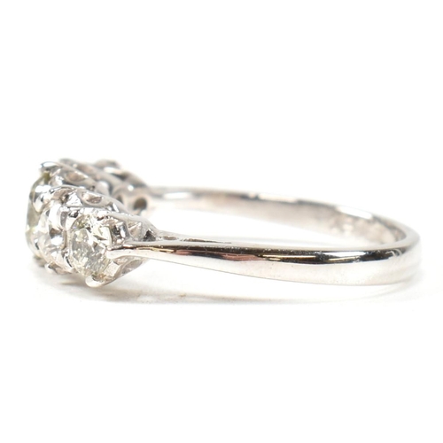 82 - A white gold and diamond five stone ring. The ring set with five graduating round brilliant cut diam... 