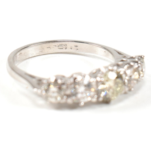 82 - A white gold and diamond five stone ring. The ring set with five graduating round brilliant cut diam... 