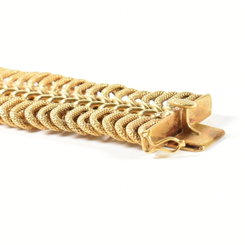 85 - A hallmarked Italian 18ct gold woven link bracelet. The 18ct gold bracelet having a central woven ch... 