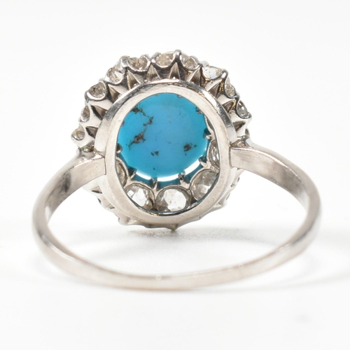 86 - A platinum, turquoise and diamond cluster ring. The ring having a central oval cut cabochon of turqu... 