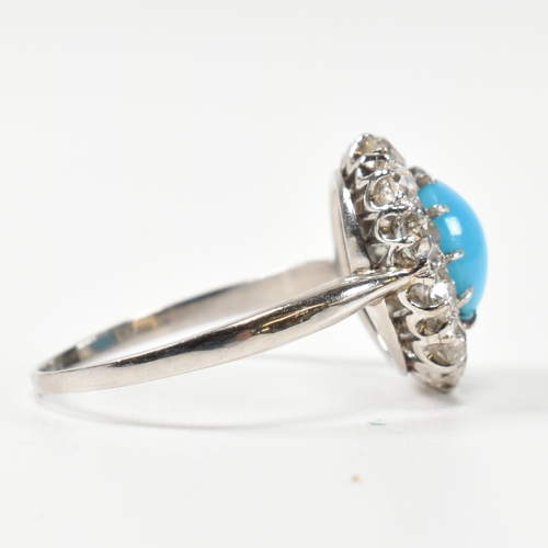 86 - A platinum, turquoise and diamond cluster ring. The ring having a central oval cut cabochon of turqu... 