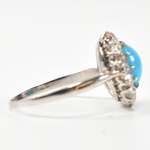 86 - A platinum, turquoise and diamond cluster ring. The ring having a central oval cut cabochon of turqu... 