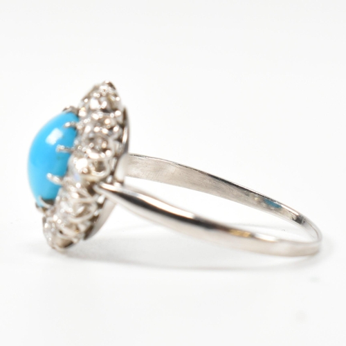 86 - A platinum, turquoise and diamond cluster ring. The ring having a central oval cut cabochon of turqu... 