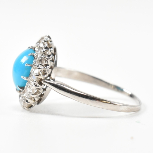 86 - A platinum, turquoise and diamond cluster ring. The ring having a central oval cut cabochon of turqu... 